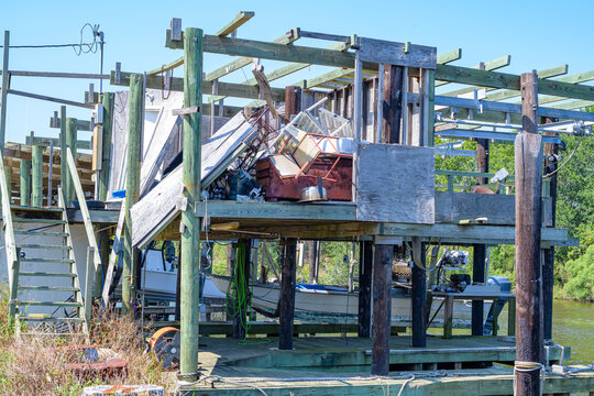 Storm Damaged Boat House with Collapsed Walls and Exposed Interior at Shell Beach, LA, USA