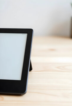 Digital reading and e-learning electronic book reader with blank screen on wooden desk for education remote study and modern lifestyle technology