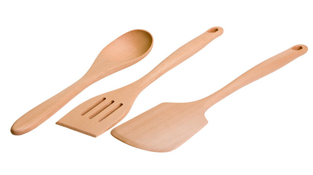 Isolated trio of natural wood cooking tools, including a serving spoon, a slotted and a flat spatula