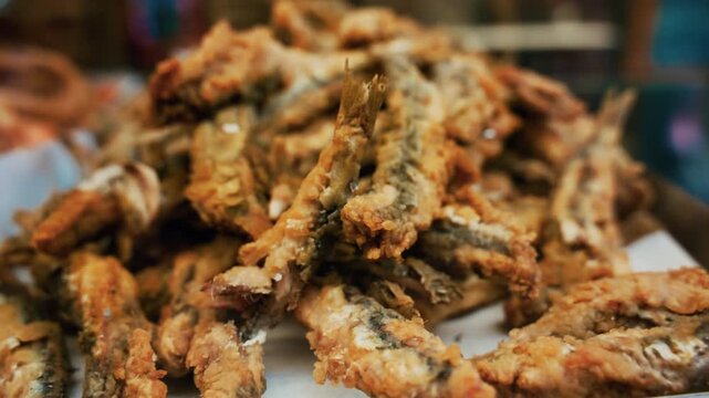 Fried breaded sardines at a street food restaurant on the Naples seafront