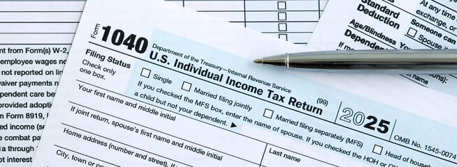 Fototapeta premium 1040 US Individual Income tax return blank form and pen on accountants table