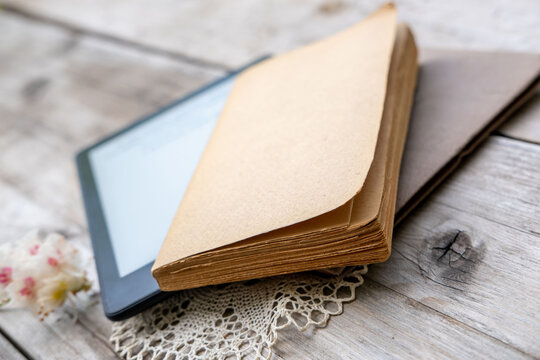 ebook reader on stack old paper books on wooden table, electronic book, digital reading device and vintage literature contrast, technology vs tradition, Back to school and education, blank copy space