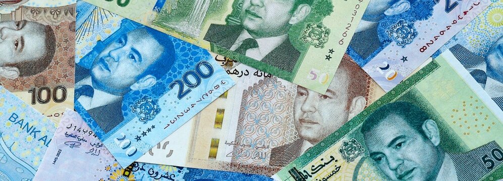 Moroccan dirham money banknotes pile on table. Morocco bills of MAD currency close up