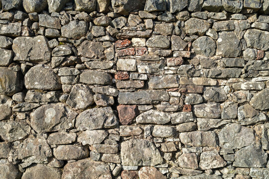 Historic stone wall along Loch Ness in the Scottish Highlands on a bright day