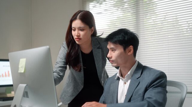 Business Team Reviewing Work on Office Computer