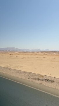 Expansive desert landscape with distant mountains under a clear blue sky Egypt. Hurghada