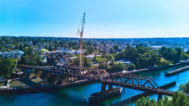 Aerial Train Bridge and Construction Crane Over Waterway in Seattle