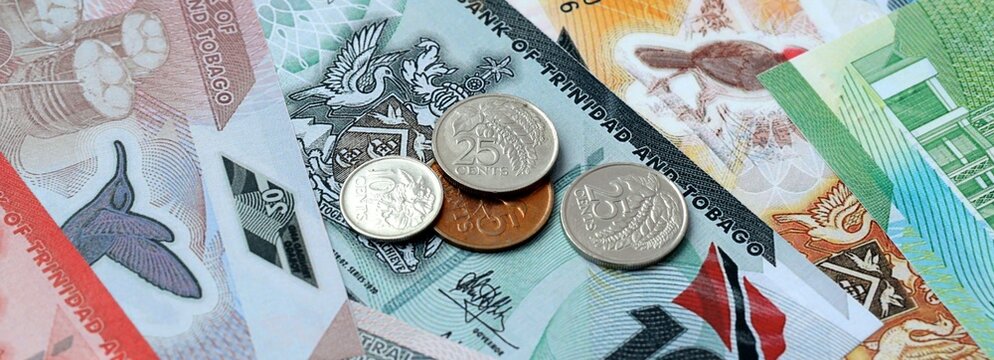 Trinidad and Tobago dollar money and coins on table. Trinidad and Tobago cash bills of TTD currency