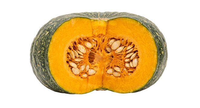 A fresh kabocha squash cut in half showing vibrant orange flesh and many seeds inside isolated