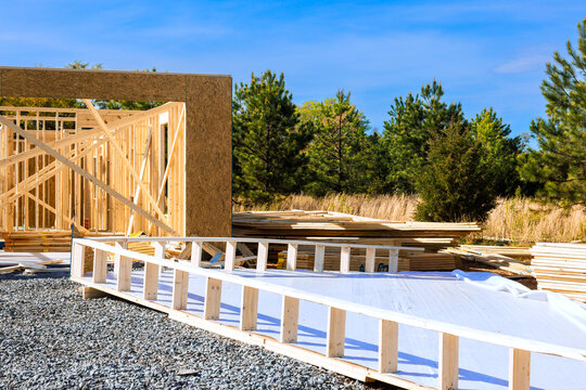 Workers build structure using wooden beams frames at site in construction area