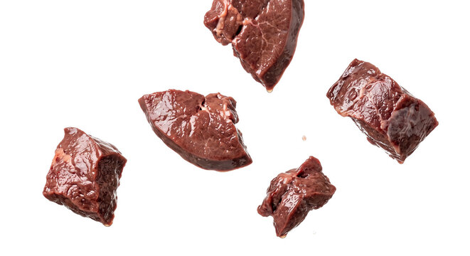 Fresh raw beef liver chunks floating against a clean white background for culinary photography