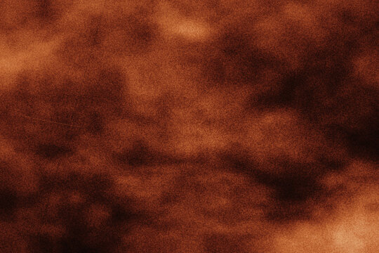 Warm brown grunge texture with soft organic cloud patterns and fine scratch details suitable for vintage book covers and rustic paper backdrops.