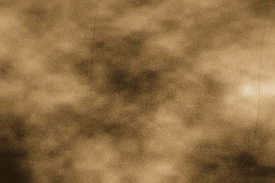 Warm brown sepia grunge texture background with soft noise cloud effects and subtle scratches suitable for antique photo overlays or warm backdrops.