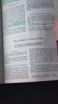 Opening to the book of Colossians of the New Testament in the Holy Bible. New Revised Standard Version. Vertical video.