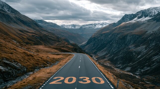 Road winds ahead past the number marking on a mountain highway with snow-capped peaks and cloudy sky in an alpine landscape.