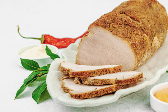 High-protein roasted pork loin served with tasty sauces, styled for food photography