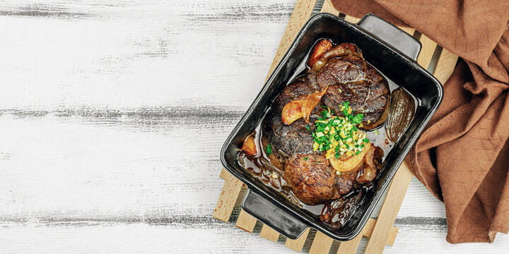 Ossobuco beef meat with spices and fresh herbs. Veal shank steak, traditional Italian ingredient