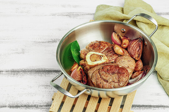 Ossobuco beef meat with spices and fresh herbs. Veal shank steak, traditional Italian ingredient