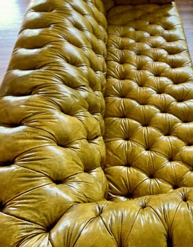 Tufted gold leather chesterfield sofa back detail