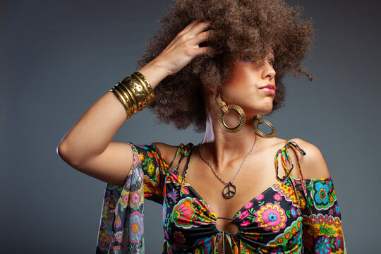 Stylish Retro Woman with Afro Hair Posing on Grey Background