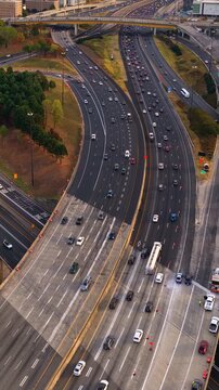 Futuristic aerial cityscape with road networks and overpasses forming transportation artery through Atlanta expanding metropolitan area. American freeway system.