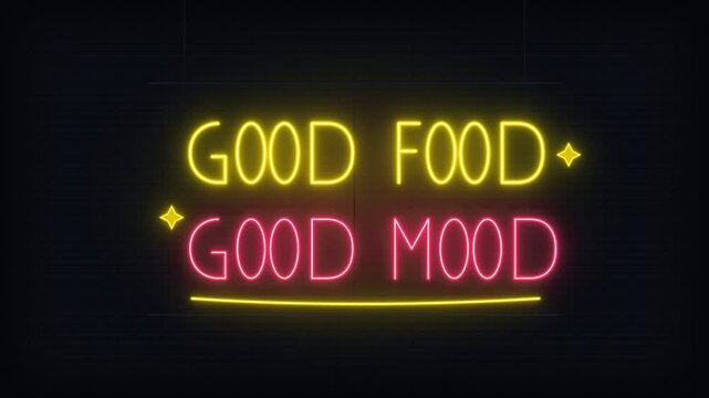Good food good mood neon sign animation glowing with vibrant yellow and pink colors against a dark textured brick background