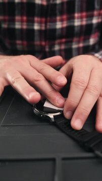 Man Prepares To Protect Modern Sport Smartwatch Screen With Glass, Close-Up View Of Device, Vertical Video