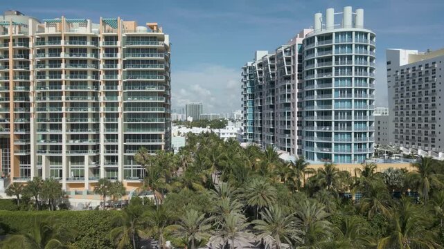 Aerial ascent revealing miami beach high rises along collins avenue