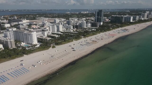 Aerial glide over miami beach hotels tracing the curve of collins avenue