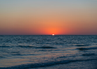 Fototapeta premium Sea sunset horizon. Sunset cloudy sky. Seascape at summer vacation. Caribbean sea. Skyscape with sea horizon. Horizon sunrise sea with waves. Sunrise seascape. Romantic summer vacation seascape