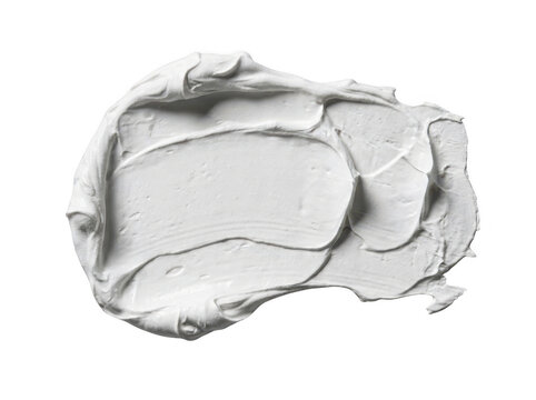 A glob of white paint or cream spread on a smooth transparent surface with organic texture.