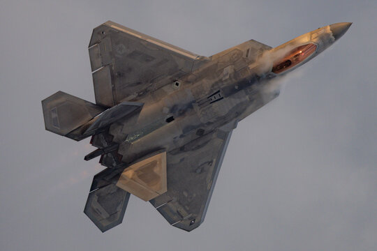 F 22 Raptor climbs steeply through a condensation cloud