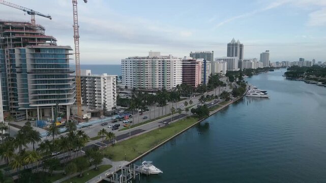 Aerial drift past a construction crane over the miami beach intracoastal waterway