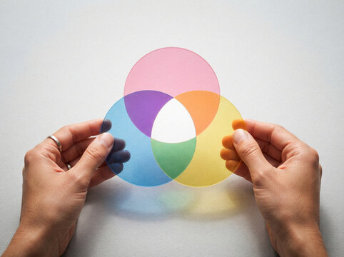 Hands holding overlapping colored circles with hands hold translucent