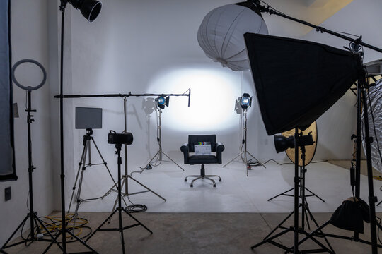 Studio, interview, movie, camera, lights empty film studio set with professional production lighting equipment