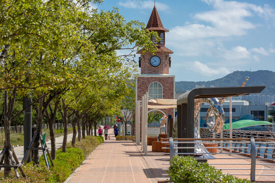 Waterfront promenade with a clock tower on a bright summer day