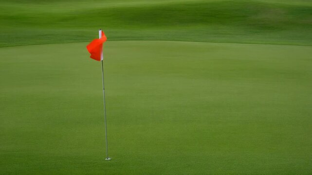 Golf flag moving on a green