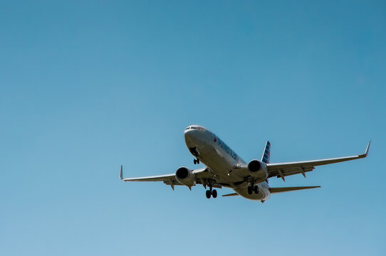 ST. LOUIS, MO &mdash; JULY 13, 2018: An American Airlines passenger jet approaches for landing against a clear blue sky.