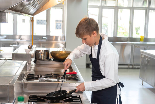 Young Chefs Student studying cooking food in class at school kitchen.