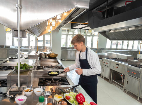 Young Chefs Student studying cooking food in class at school kitchen.