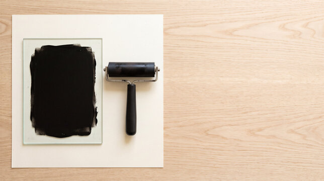 Black ink on glass plate with roller