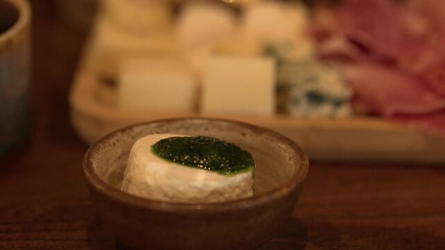 Fresh Goat Cheese with Green Pesto Dip in Rustic Bowl