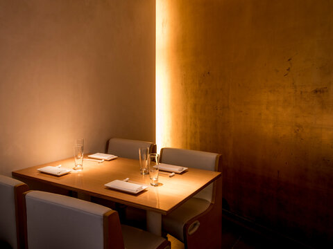 A intimate corner dining table set for four in an upscale restaurant.