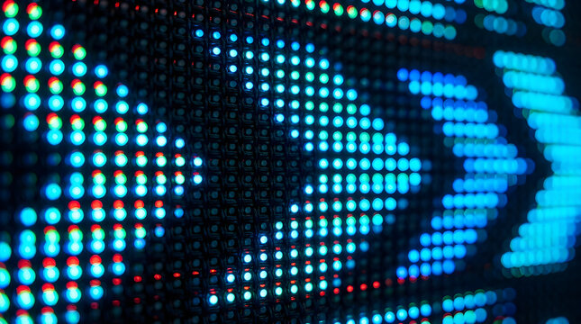Bright cyan arrows displayed on high resolution digital led matrix screen