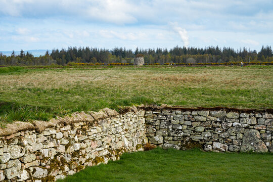 Culloden Battlefield near Inverness in Scotland. Historic site of the famous 1746 battle with traditional stone walls, green grass fields, and the memorial cairn in the far background 