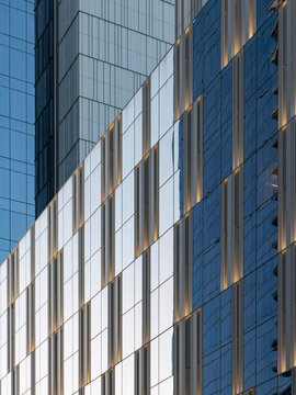 Close-up view of a contemporary high-rise hotel exterior showing two adjoining facade sections.