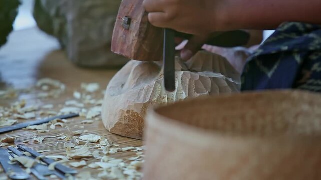 Close Up Artisan Hand Carving Wood with Gouge Chisel