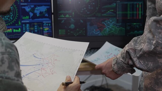 Military Officers Analyzing Tactical Map and Radar Display Monitors in Command Center