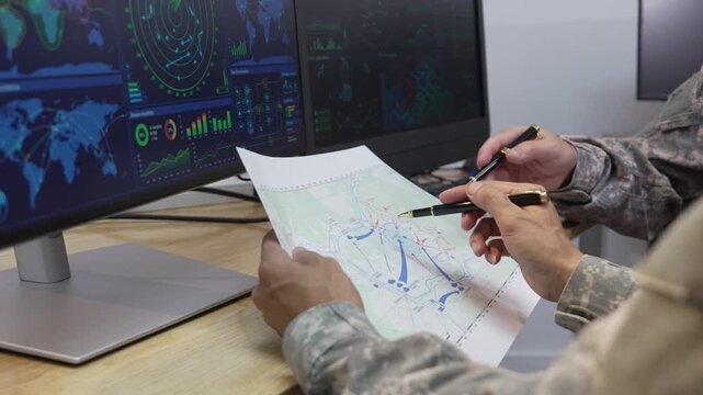 Military Officers Analyzing Tactical Map and Radar Display Monitors in Command Center