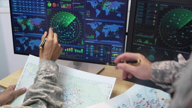 Military Officers Analyzing Tactical Map and Radar Display Monitors in Command Center